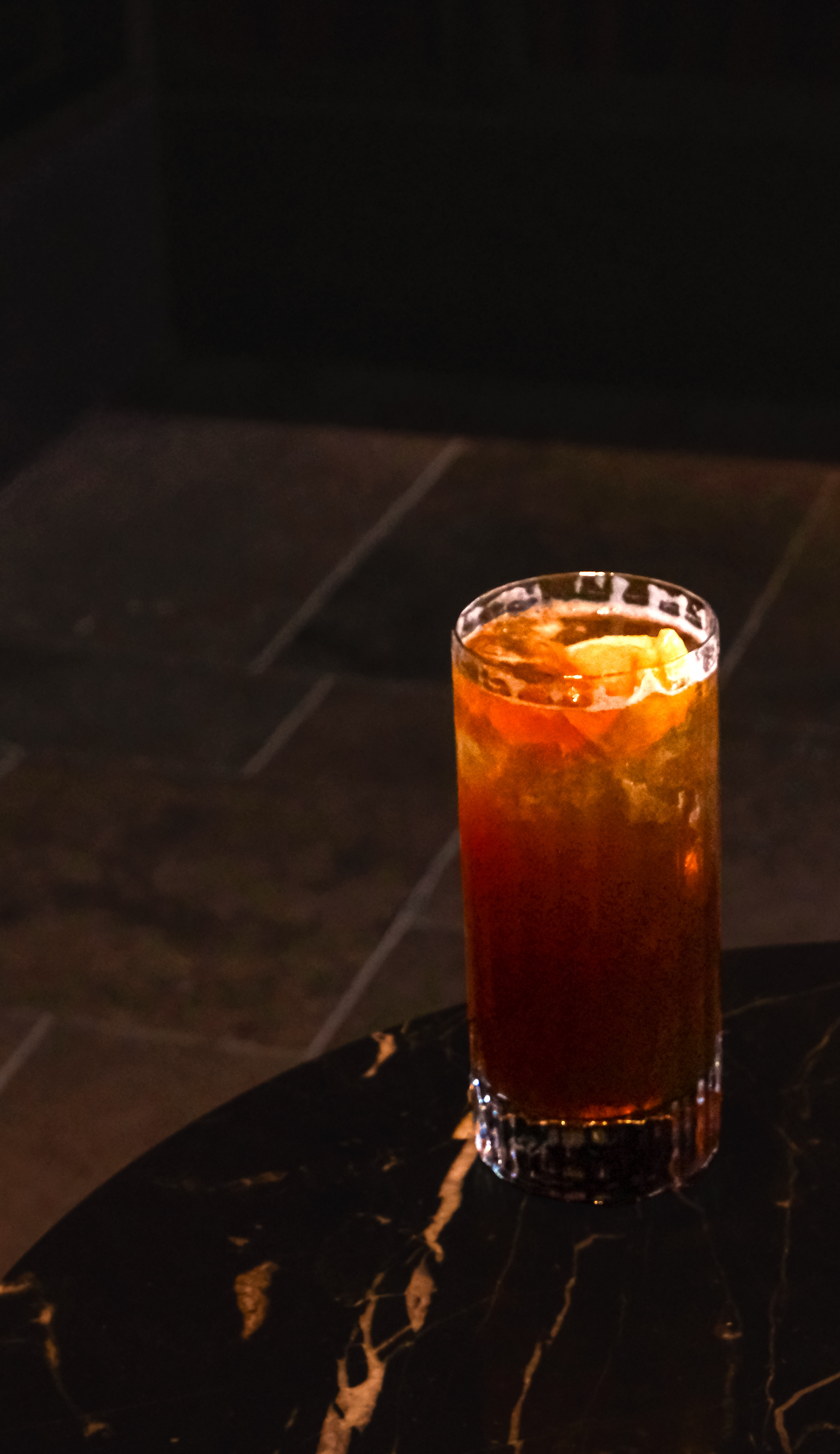 Peach & Proper — dark amber cocktail