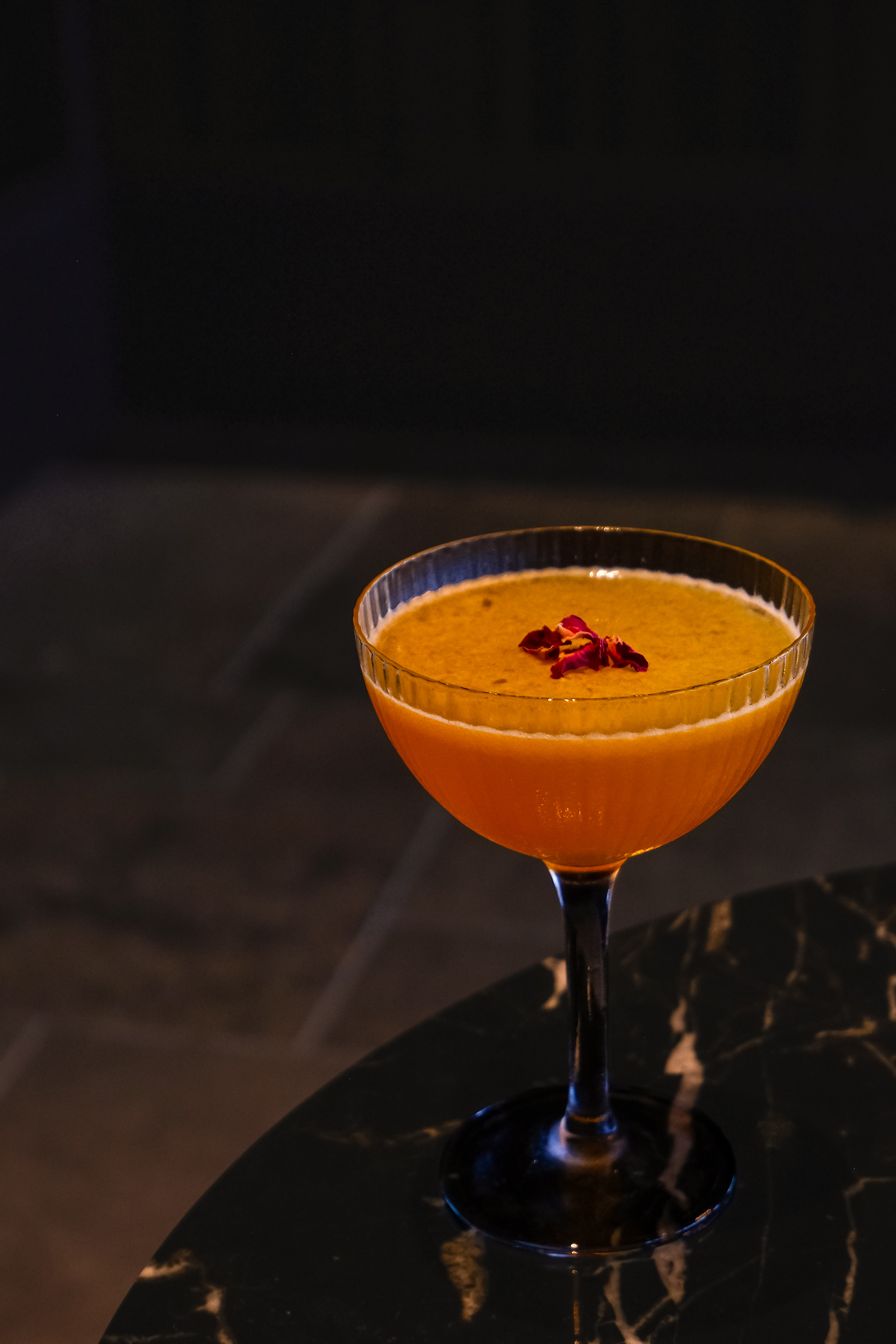 The Passion Life — cocktail with rose petal garnish